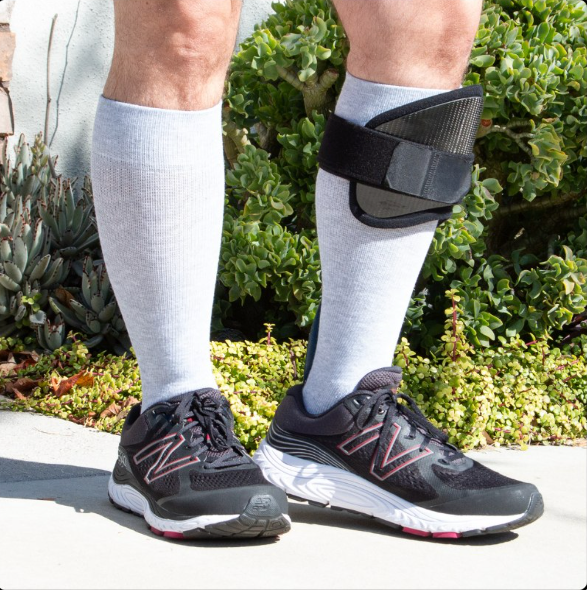 Neotrek knee-high light compression socks worn with athletic shoes and AFO brace, designed for partial-foot amputees and ideal for use with orthotics.